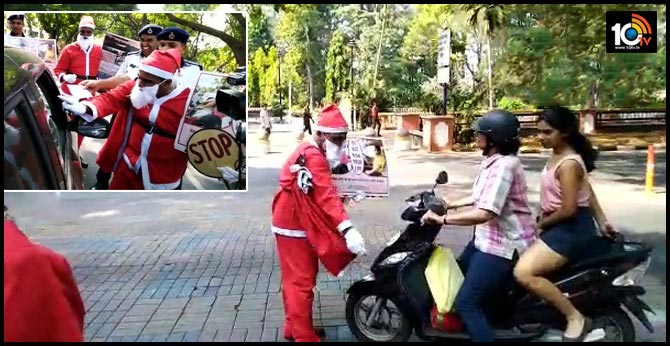 Traffic Police personnel dressed as SantaClaus and distributed sweets