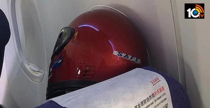 flight passenger wears helmet for protection from coronavirus